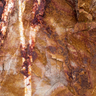 Rośe on the Rocks Australian fine art photography print featuring natural rock textures in warm rust, terracotta, ochre and soft pink tones, with intricate cracks and weathered patterns.